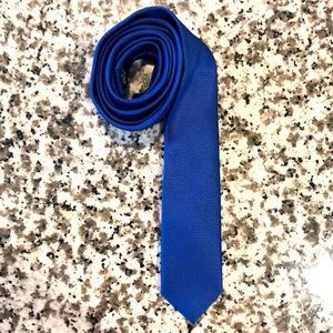 Vibrant blue skinny neck tie, 2” at the base.